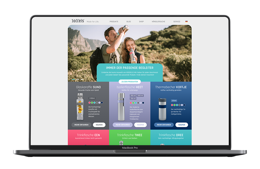 Das Bild zeigt einen Laptop mit einem Ausschnitt aus der Website von Boddels. Man erkennt zuoberst ein Bild mit Menschen in der Natur, darunter bunte Kacheln mit den einzelnen Produkten.